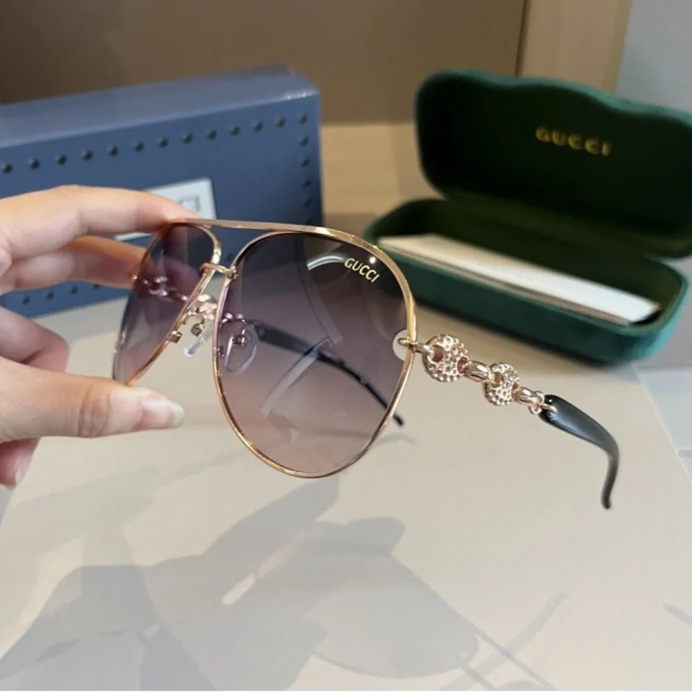 Gucci Women's Black and Gold Sunglasses
